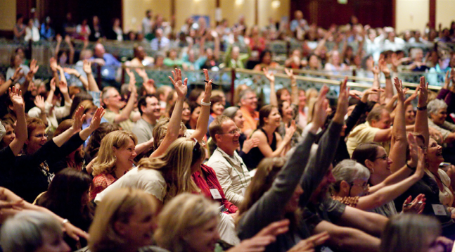 Image of Individuals at a Conference and Q & A