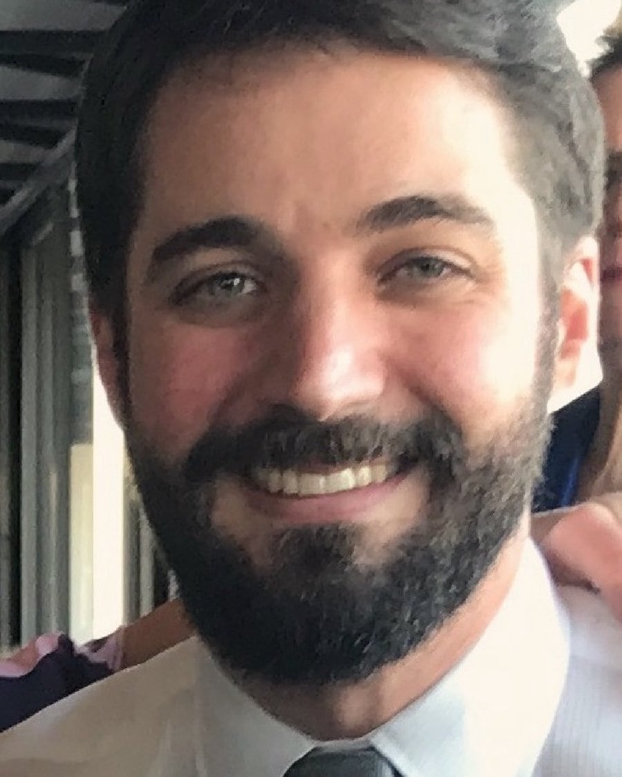 Friendly man with beard and mustache smiling